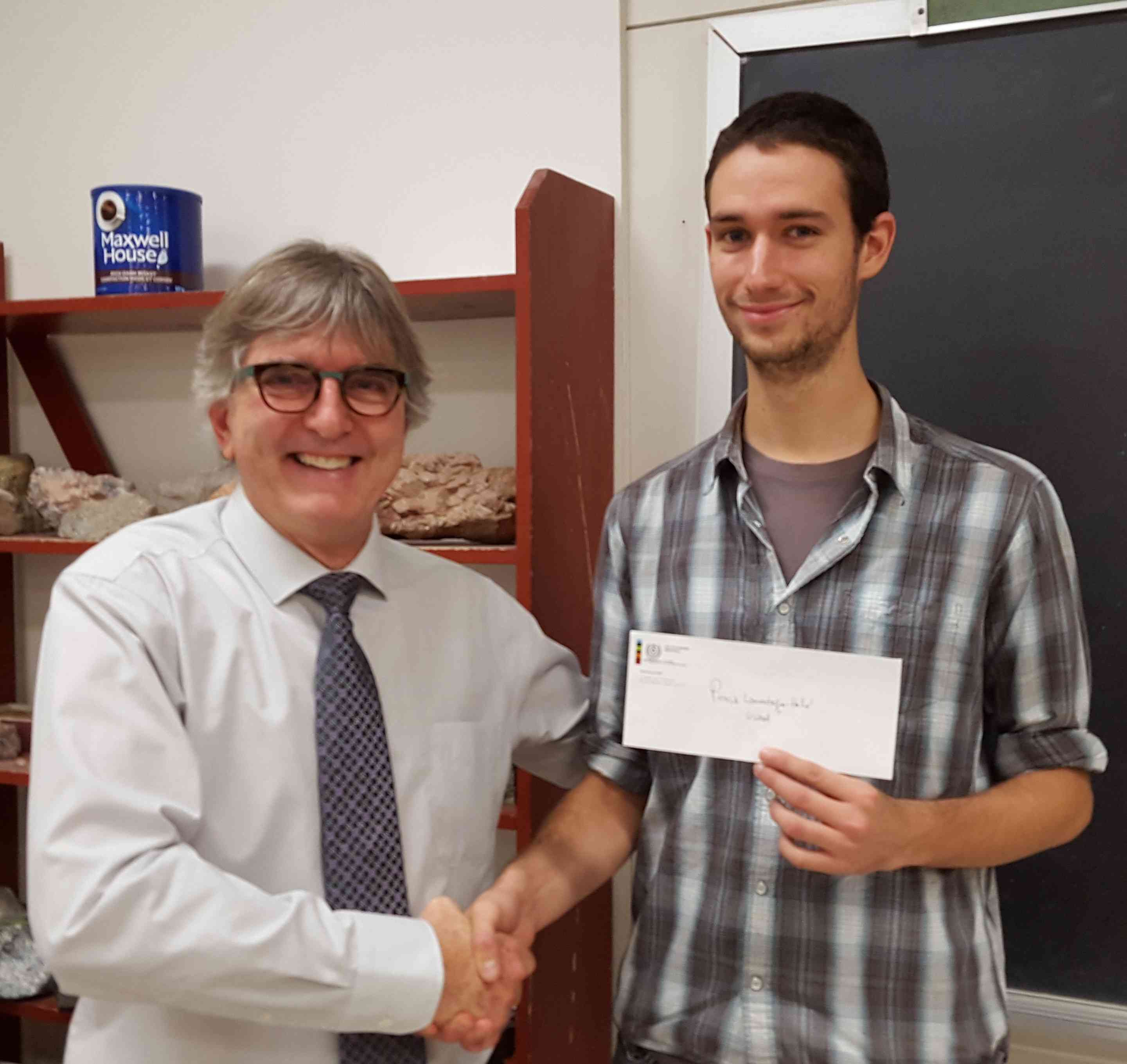 Pierrick Lamontagne-Hallé (MSc, Laval U) receiving award from Prof. Michel Chouteau, Ecole Polytechnique at KEGSF Special Lecture, Nov 12.